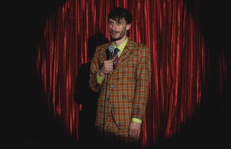 Richard Gadd as Donny Dunn in a plaid suit on stage