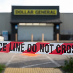 Crime scene tape stretches across the property of a Dollar General store where three people were shot and killed two days earlier on August 28, 2023 in Jacksonville, Florida.