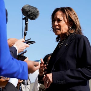 Kamala Harris speaks with reporters before boarding Air Force Two.