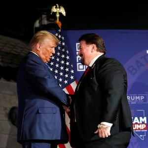 Former U.S. President Donald J. Trump greets Michael McDonald, state chairman of the Nevada Republican Party, at a Team Trump Nevada Commit to Caucus rally in Las Vegas