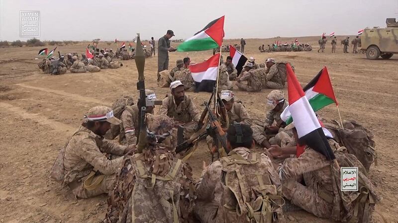 Houthi fighters gather during a military maneuver near Sanaa, Yemen.