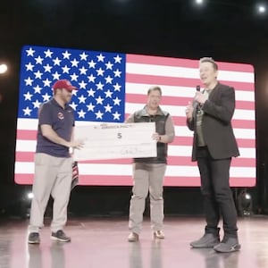 Elon Musk presents a $1 million vanity check to a Pennsylvania voter on behalf of his America PAC.