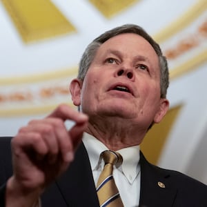 Steve Daines speaks to reporters into the U.S. Capitol.