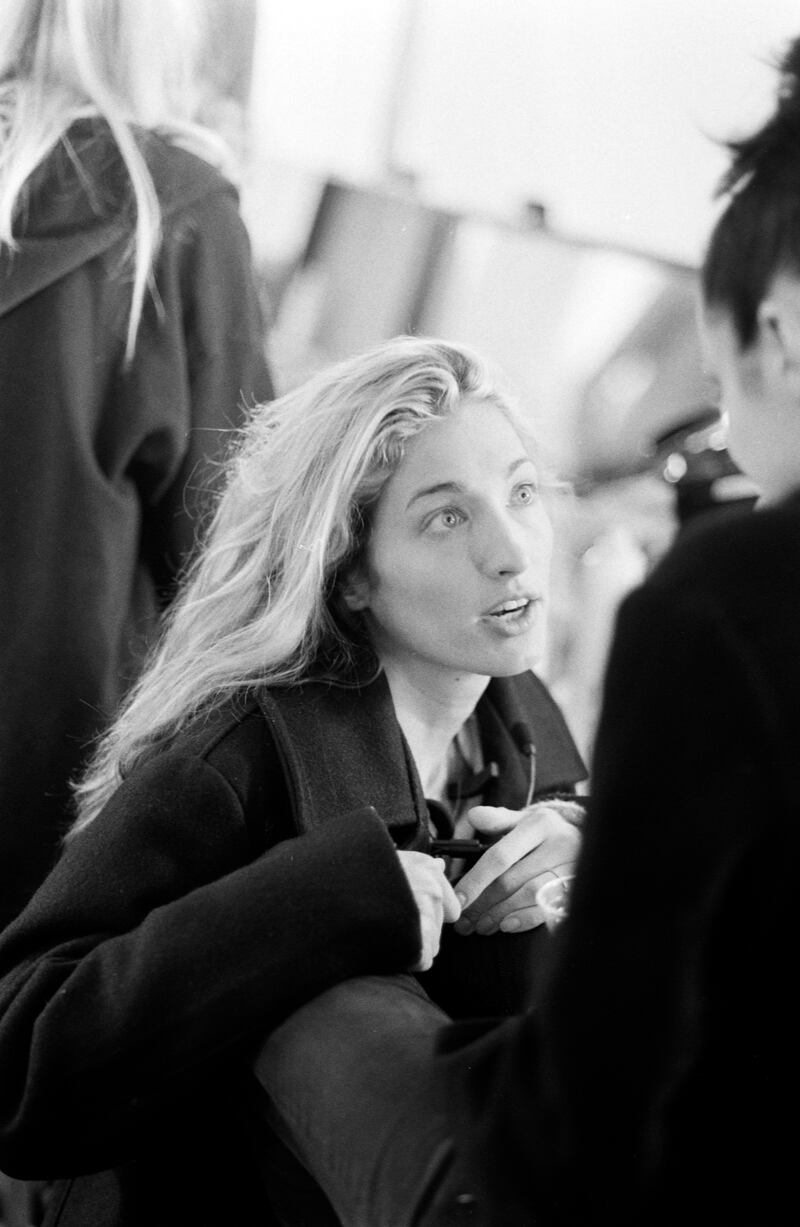 Carolyn Bessette-Kennedy talks with a model backstage at the Fall-Winter 1995 Calvin Klein runway show during New York Fashion Week on April 7,1995.