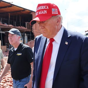 President Donald Trump prepares to leave after visiting Chez What Furniture store, which was damaged during Hurricane Helene.