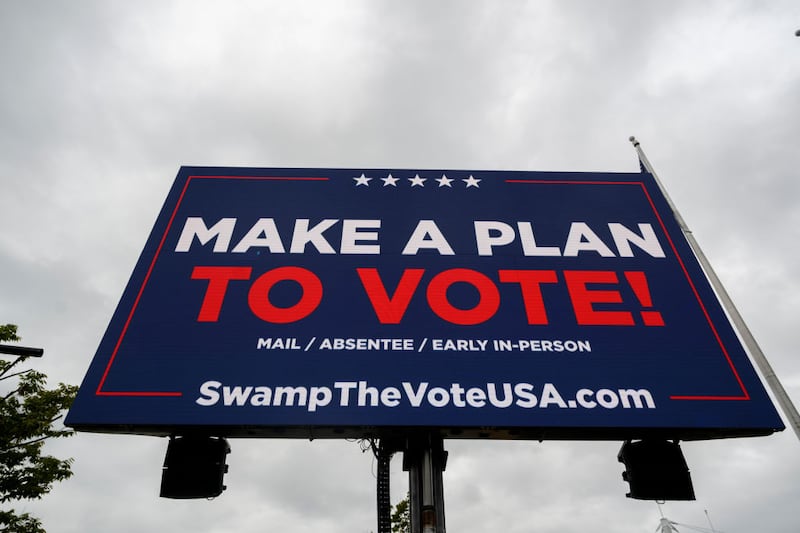 A sign highlights efforts to sign up voters at the Bayfront Convention Center before a campaign rally for Donald Trump in Erie, Pennsylvania.