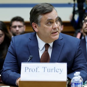 Jonathan Turley looks to the left while speaking during a House committee meeting.