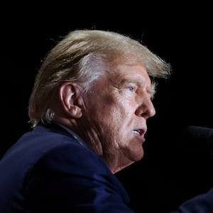 Donald Trump speaks with his hand up during a campaign event.