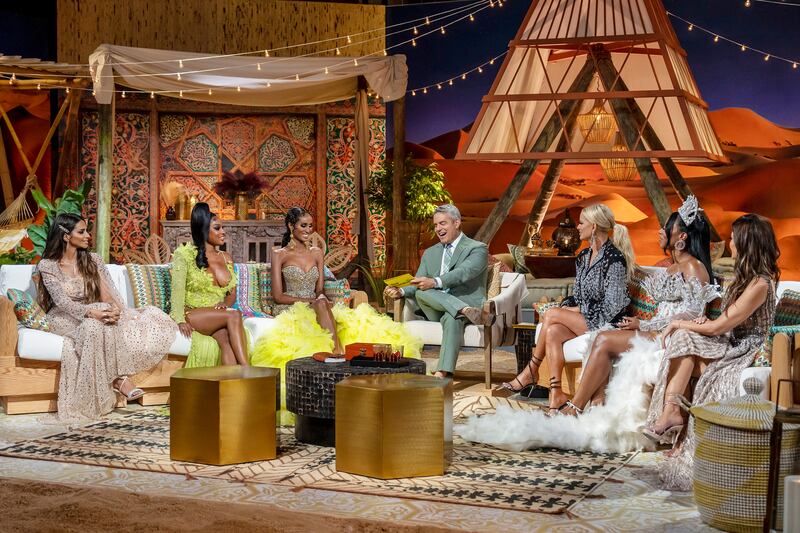 Photo still of Sara Al Medani, Lesa Milan, Chanel Ayan, Andy Cohen, Caroline Stanbury, Caroline Brooks, and Nina Ali at the Real Housewives of Dubai reunion.