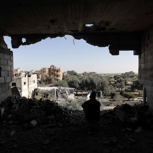 A photograph of a Palestinian citizens inspecting the effects of destruction caused by air strikes on their homes in the Khuza’a area on November 24, 2023 in Khan Yunis, Gaza.