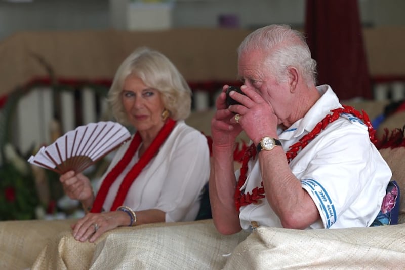 British King Charles III drinks kava, which the locals call "Ava"as Queen Camilla watches the kava ceremony to welcome members of the royal family in the village of Moata in the Samoan capital Apia, October 24, 2024.