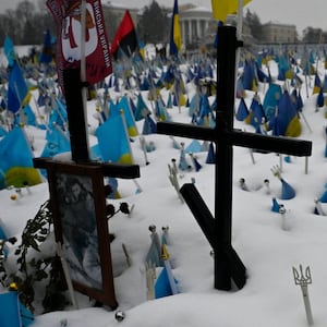 Crosses in the snow with Ukrainian flags 