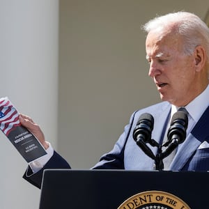 President Joe Biden holds U.S. Senator Rick Scott's (R-FL) \"12-point plan to Rescue America,\" as he speaks at an event on health care costs, Medicare and Social Security, in the Rose Garden at the White House. 