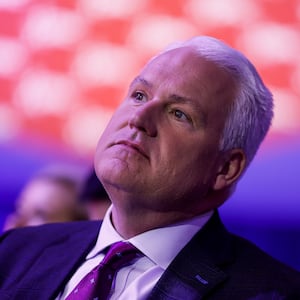 Matt Schlapp listens as Kimberly Guilfoyle speaks during the annual Conservative Political Action Conference (CPAC).