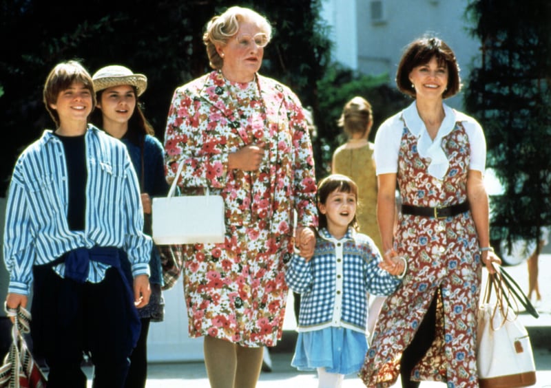 Matthew Lawrence, Lisa Jakub, Robin Williams, Mara Wilson, Sally Field hold hands and stand in the street in a still from Mrs. Doubtfire