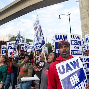 Protesters march through the streets of downtown Detroit amid UAW strike