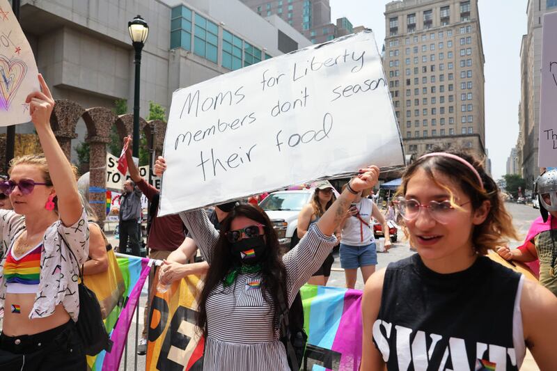 People protest the Moms for Liberty Joyful Warriors national summit outside the Philadelphia Marriott Downtown.