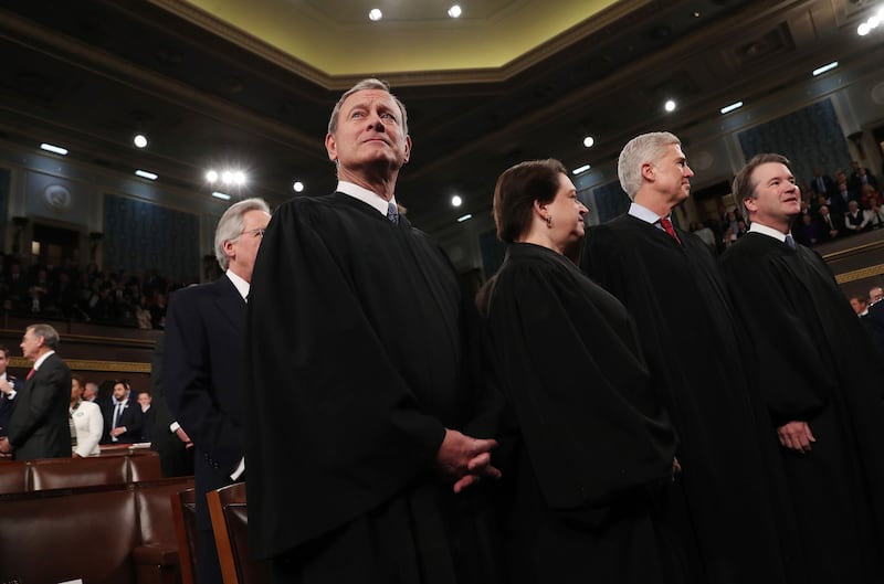 A picture of John Roberts, Elena Kagan, Neil Gorsuch, and Brett Kavanaugh standing inside of the capital