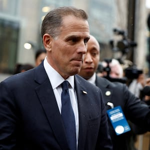 Hunter Biden walks past reporters and their microphones after a deposition in Washington.