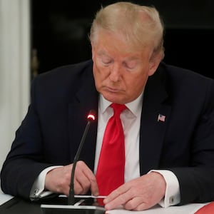 U.S. President Donald Trump is seen tapping the screen on a mobile phone