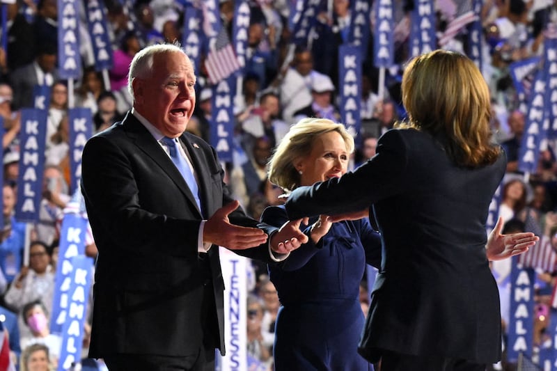 Tim Walz (L) and wife Gwen approach US Vice President and 2024 Democratic presidential candidate Kamala Harris at the conclusion of the fourth and last day of the Democratic National Convention.