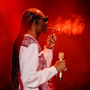 Rapper Snoop Dogg smokes as he performs during a celebration of hip hop in the Bronx at Yankee Stadium on Aug. 11, 2023.