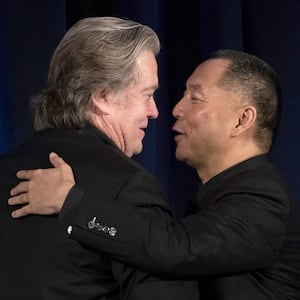 Former White House Chief Strategist Steve Bannon (L) greets Chinese billionaire Guo Wengui