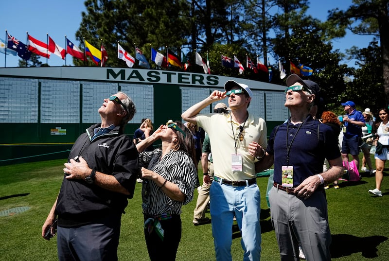 Spectators at the Masters in Augusta, Georgia, view the eclipse.