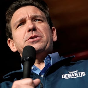 Ron DeSantis speaks at an Iowa campaign event with a microphone in hand.