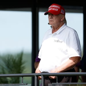 Former President Donald Trump looks on from a hospitality suite on the eighteenth green during the second round of LIV Golf Washington, D.C. golf tournament at Trump National. 