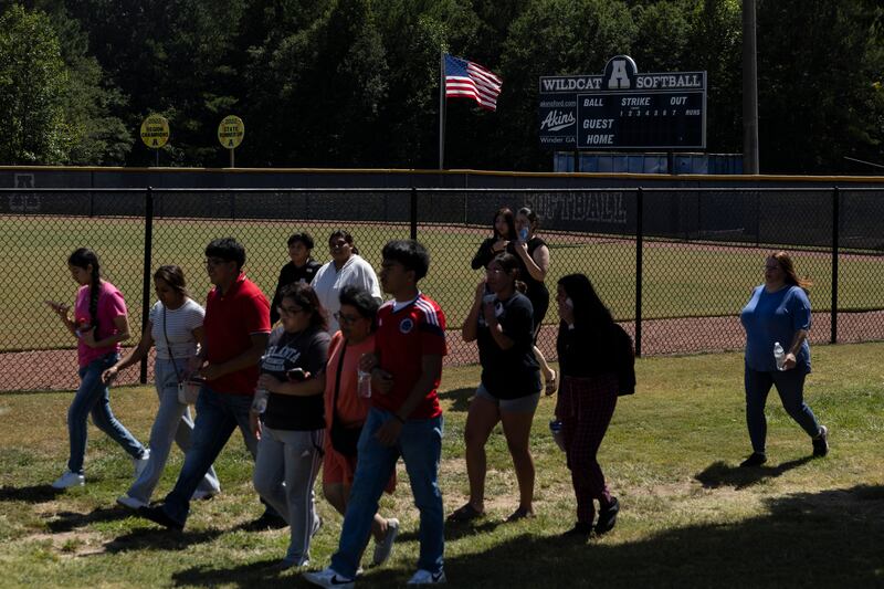 Parents and students leave the campus after a shooting took place at Apalachee High School in Winder, Georgia