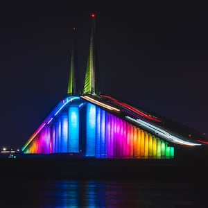 Rainbow colors illuminate the Sunshine Skyway Bridge in Florida.