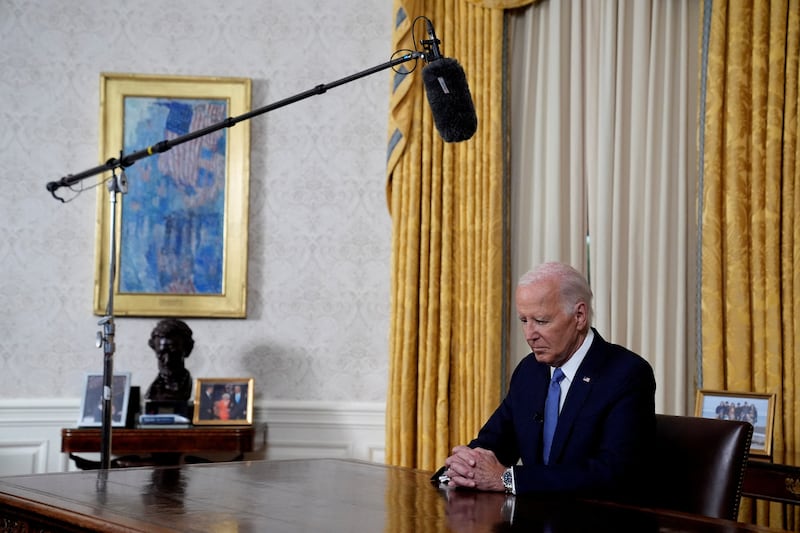 Biden at the Resolute desk looking down