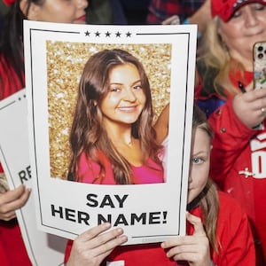 Donald Trump supporters hold posters with a photo of Laken Riley that read, ‘Say Her Name.”