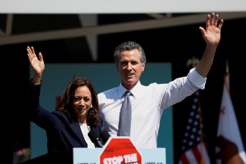 Kamala Harris and Gavin Newsom wave after Newsom's appearance ahead of the Republican-led recall election in September, in San Leandro, California, U.S., September 8, 2021.