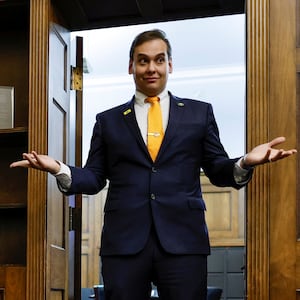 U.S. Representative George Santos (R-NY) chats with his State of the Union guest and members of his staff as they prepare for the evening in Santos’s office on Capitol Hill in Washington.