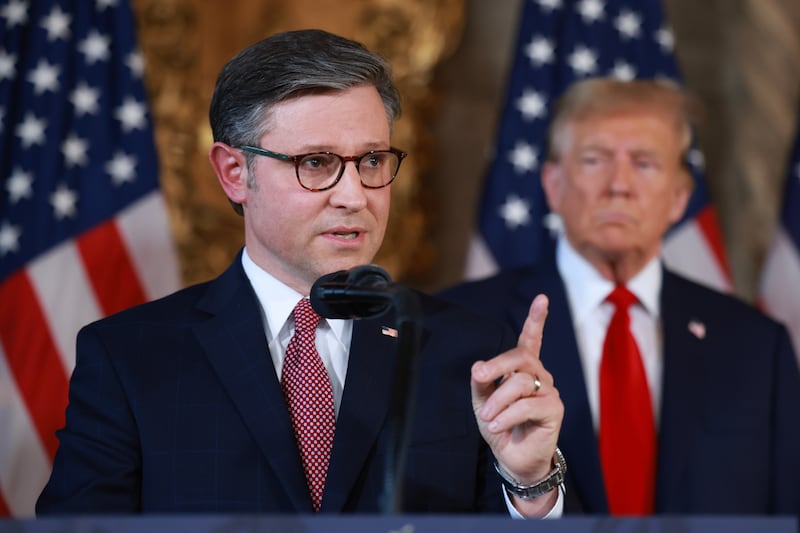 Former president Donald Trump listens as Speaker Mike Johnson (R-LA) speaks during a press conference at Mr. Trump's Mar-a-Lago estate.