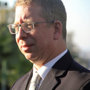 Ofir Gendelman looks forward during an interview outside.