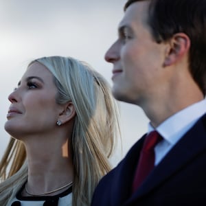 Ivanka Trump and Jared Kushner watch on during an outdoor speech