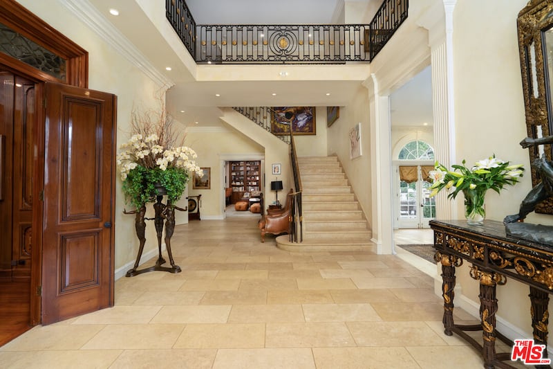 Italian limestone flooring features throughout the home in its current state.