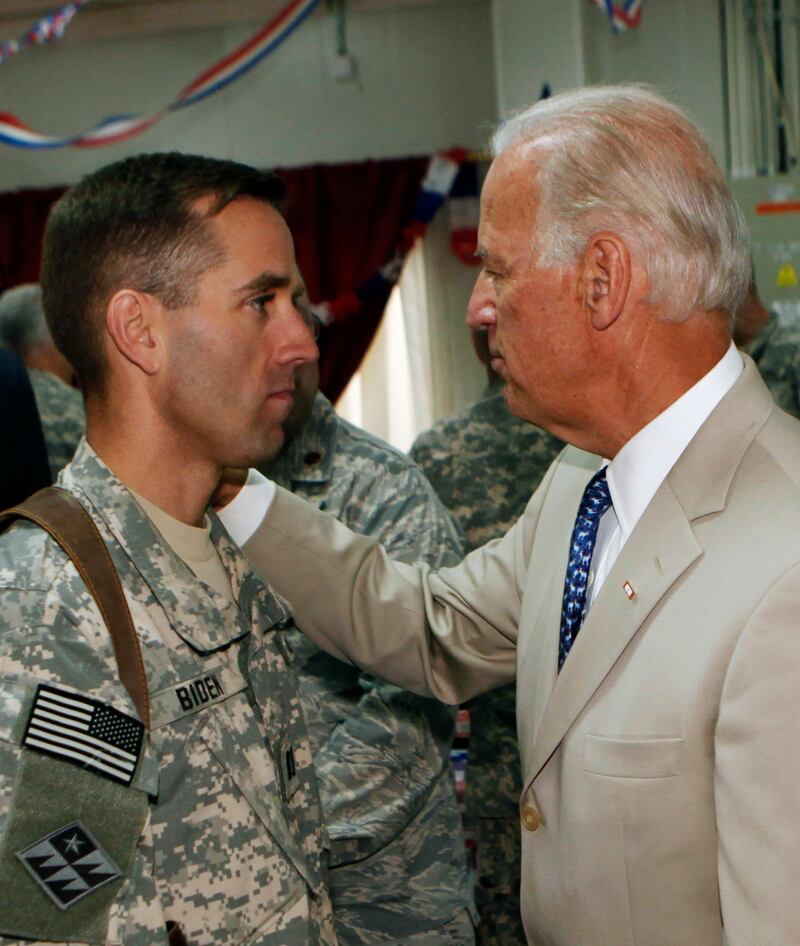 Beau and Joe Biden look at each other while meeting on military base