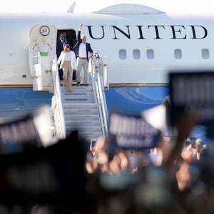 Democratic U.S. presidential candidate Vice President Kamala Harris and Democratic vice presidential candidate Minnesota Gov. Tim Walz walk off an aircraft.