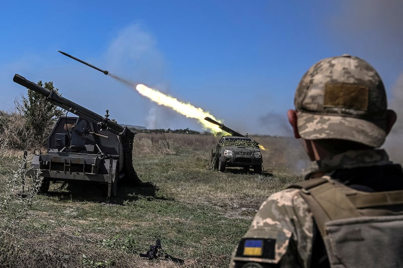 Ukrainian servicemen fire small multiple launch rocket systems towards Russian troops.