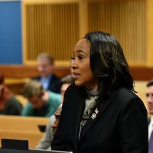 Fani Willis in suit blazer speaking at a hearing in Fulton County Courthouse in Atlanta.