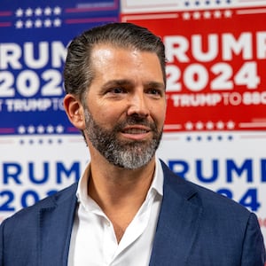 Donald Trump Jr. speaks to media at a rally for his father, Republican presidential candidate Donald Trump.