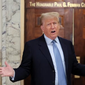 Former U.S. President Donald Trump speaks in the hall way as he attends his Manhattan courthouse trial in a civil fraud case in New York, U.S.