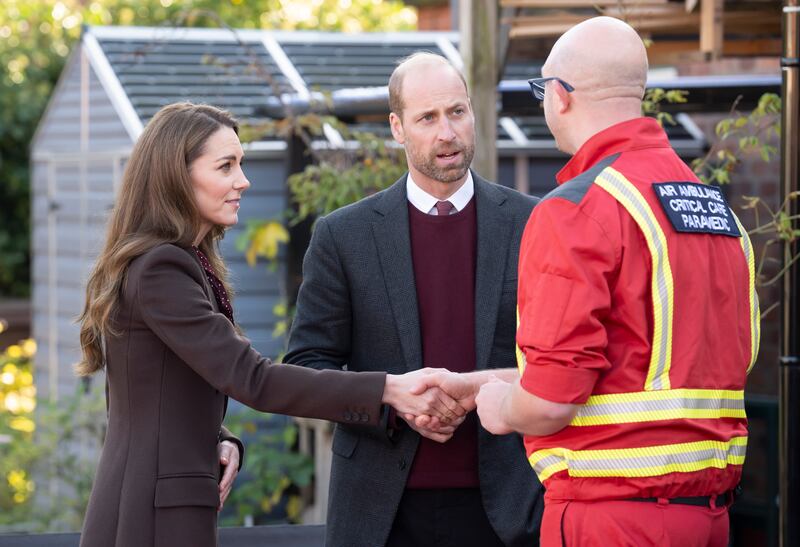 Prince William, Prince of Wales and Catherine, Princess of Wales speak with members of the Emergency Services during a visit to Southport Community Centre.