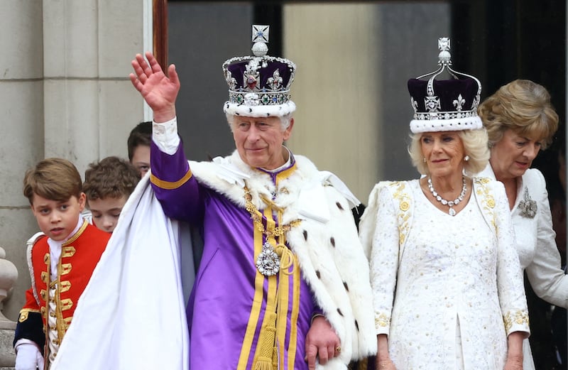 King Charles, left, and Queen Camilla stand on the Buckingham Palace balcony following their coronation ceremony in London, Britain May 6, 2023.