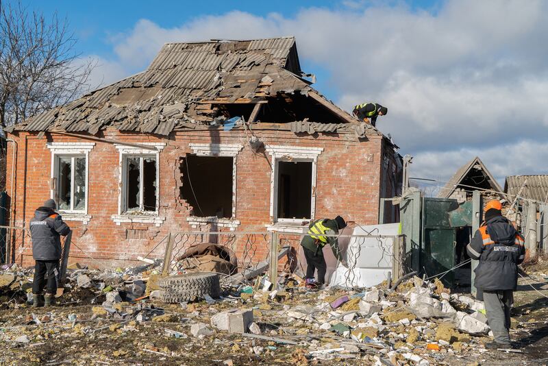 A house in Zolochiv stands in ruins with residents work to repair its damage.