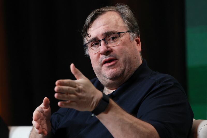 Reid Hoffman speaks on stage at an event.